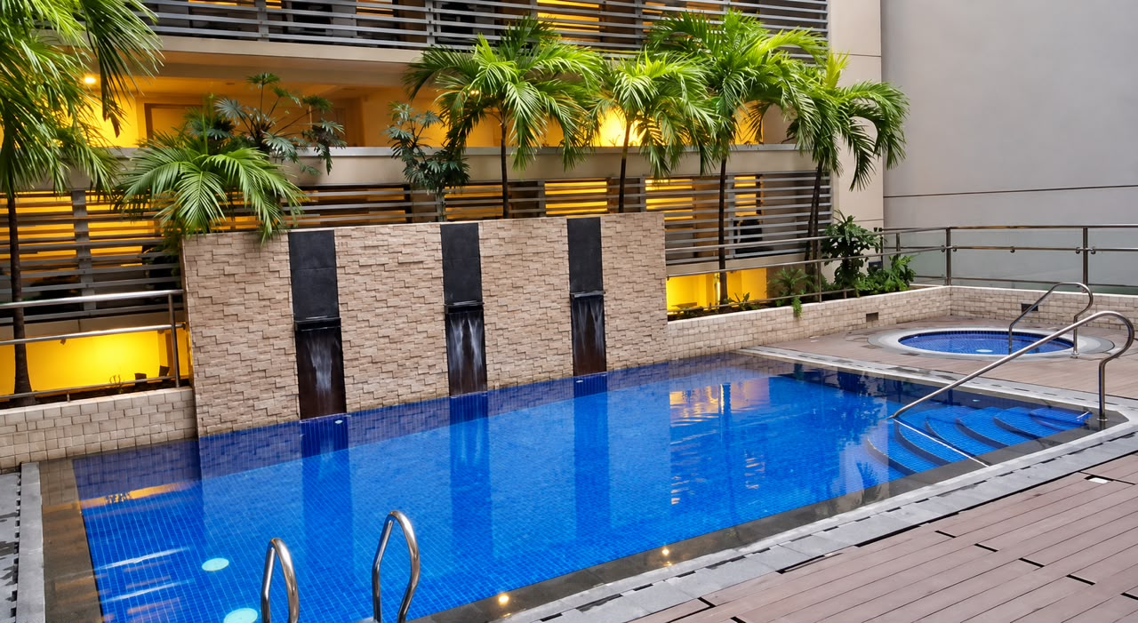 Resort-style swimming pool with waterfall feature and jacuzzi available to guests