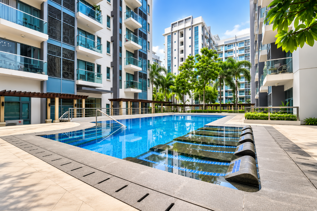 Resort-style pool with sun loungers and lush palm landscaping at Briana's Haven