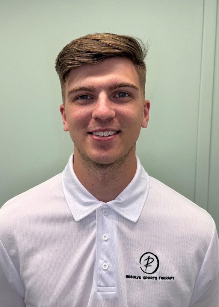 Ice, Clinical Director of Resolve Movement, wearing a white polo shirt with the Resolve Sports Therapy logo