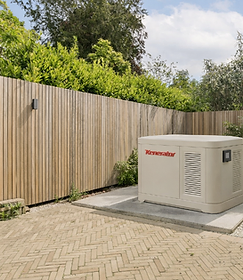 Kenerator standby backup generator installed on a concrete pad in a residential backyard