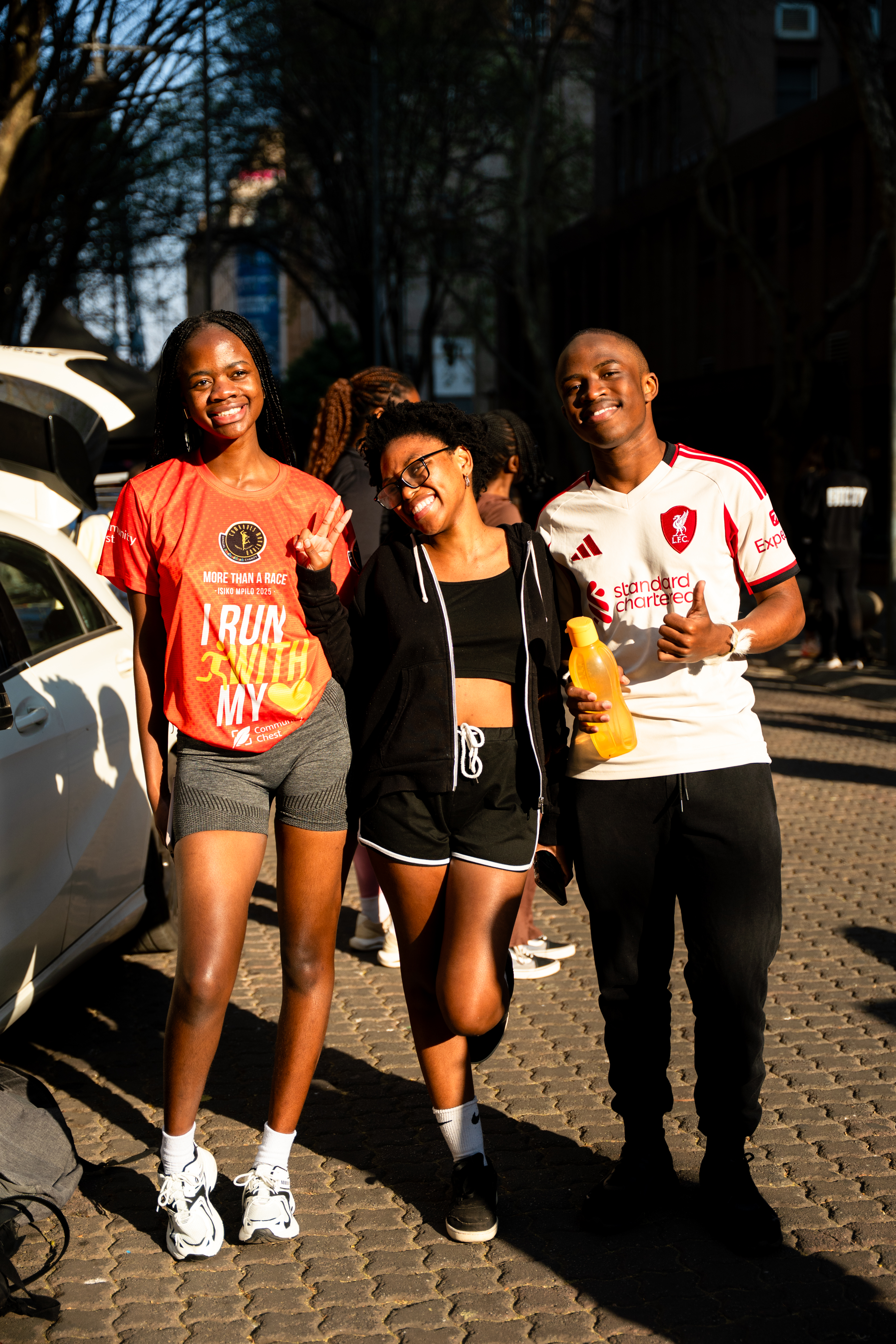 Three runners walking together along a Johannesburg street at golden hour