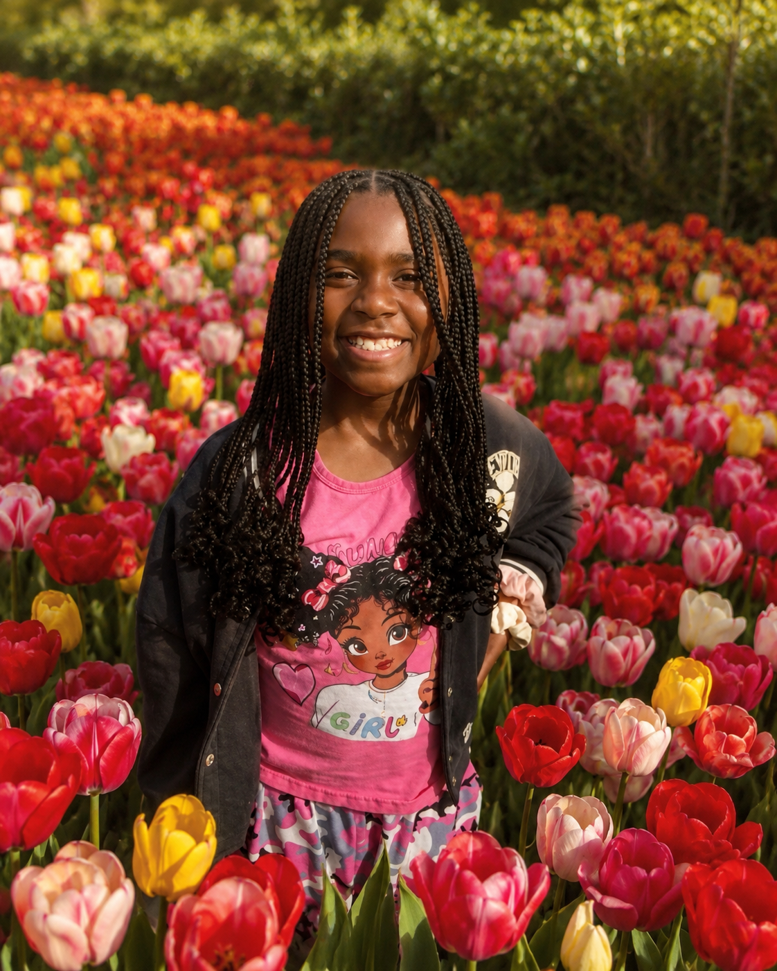 Harlyn smiling in a field of tulips