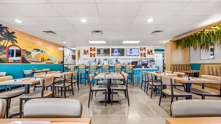 Bandoleros Café wide dining room with VW bus beach mural and teal wainscoting — hospitality interior design in Huntington Beach, CA by Studio Fridae