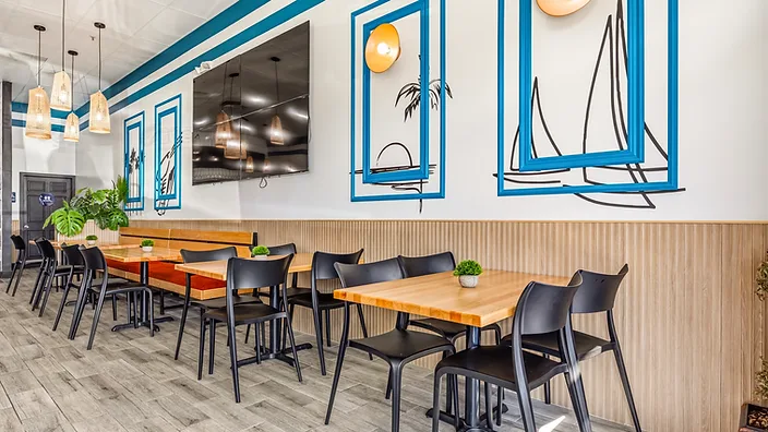 Mariscos El Güero banquette seating with burnt-orange cushions — hospitality interior design in San Bernardino, CA by Studio Fridae, an example of finish level in full-service design