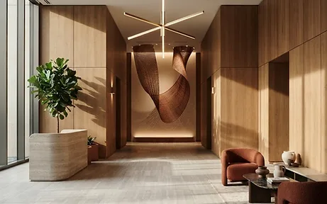 Lobby reception desk in warm wood and brushed brass — commercial interior design in Los Angeles, CA by Studio Fridae