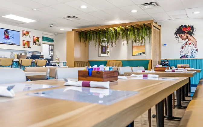 Bandoleros Café — full dining room with hanging greenery pergola and beach mural — hospitality interior design in Huntington Beach, CA by Studio Fridae