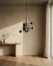 Custom pendant lighting over a stone dining table — residential interior design in Newport Beach, CA by Studio Fridae