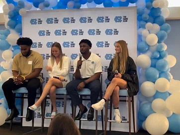Elijah Green seated on a panel discussion at The Rams Club event
