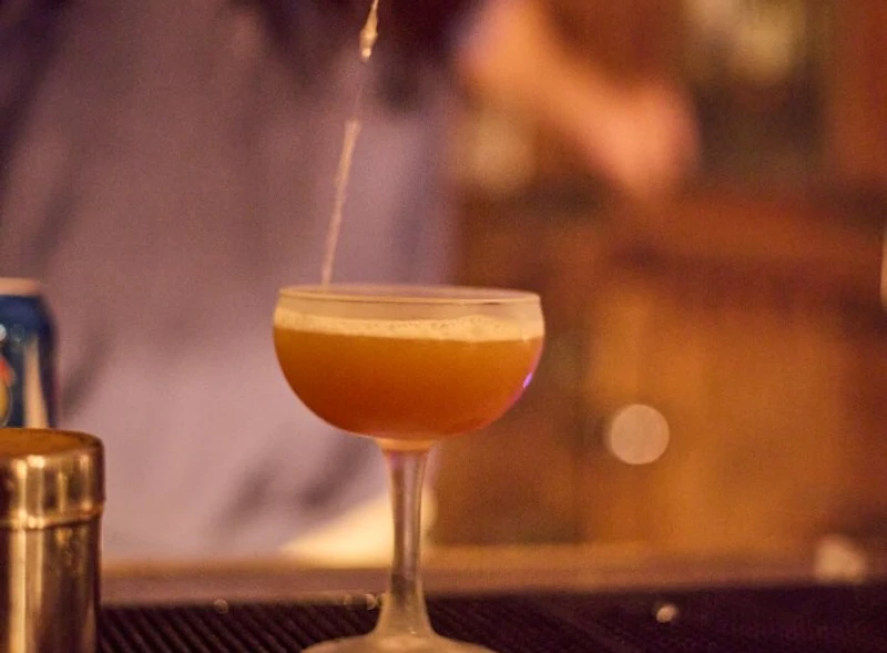 A craft cocktail poured into a coupe glass at Saint Tuesday, Tribeca NYC