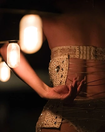 Close-up of a burlesque performer's beaded corset back at Saint Tuesday