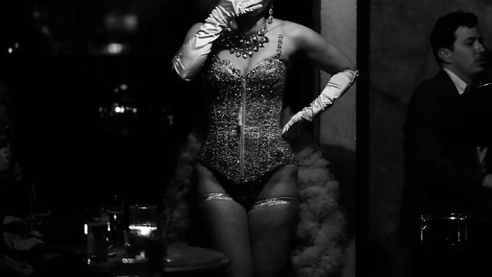 Burlesque performer in a sequined corset at Saint Tuesday