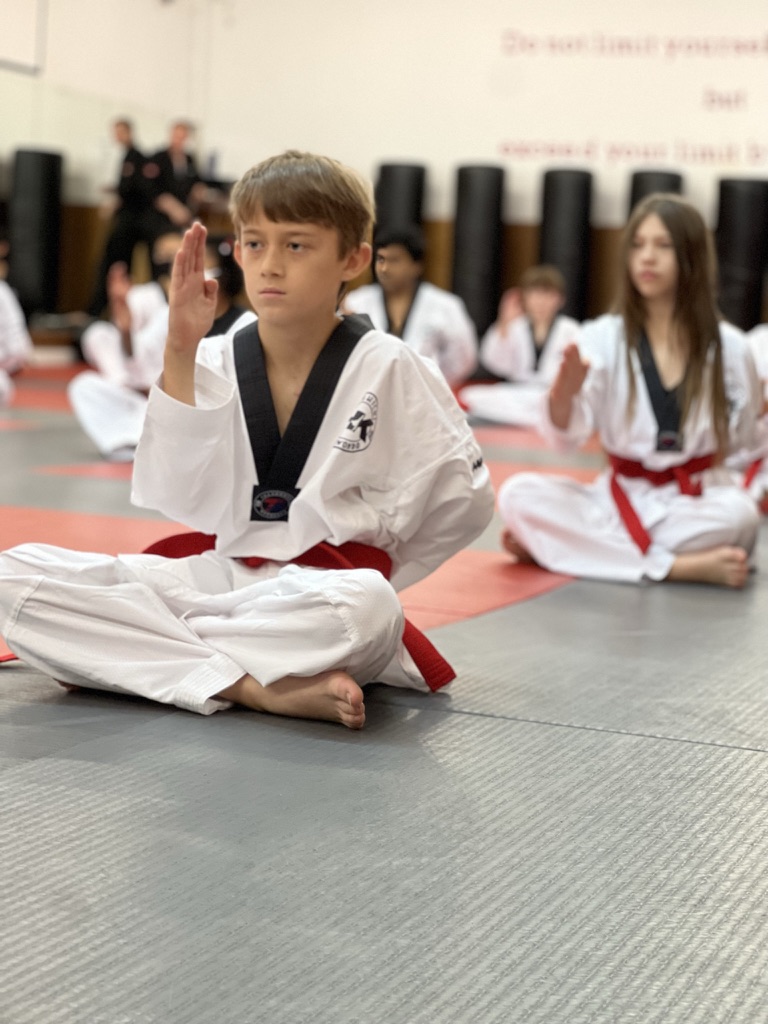 A young Highkicks student practicing on the training mat