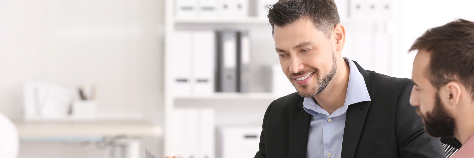 An immigration consultant reviewing documents with a client