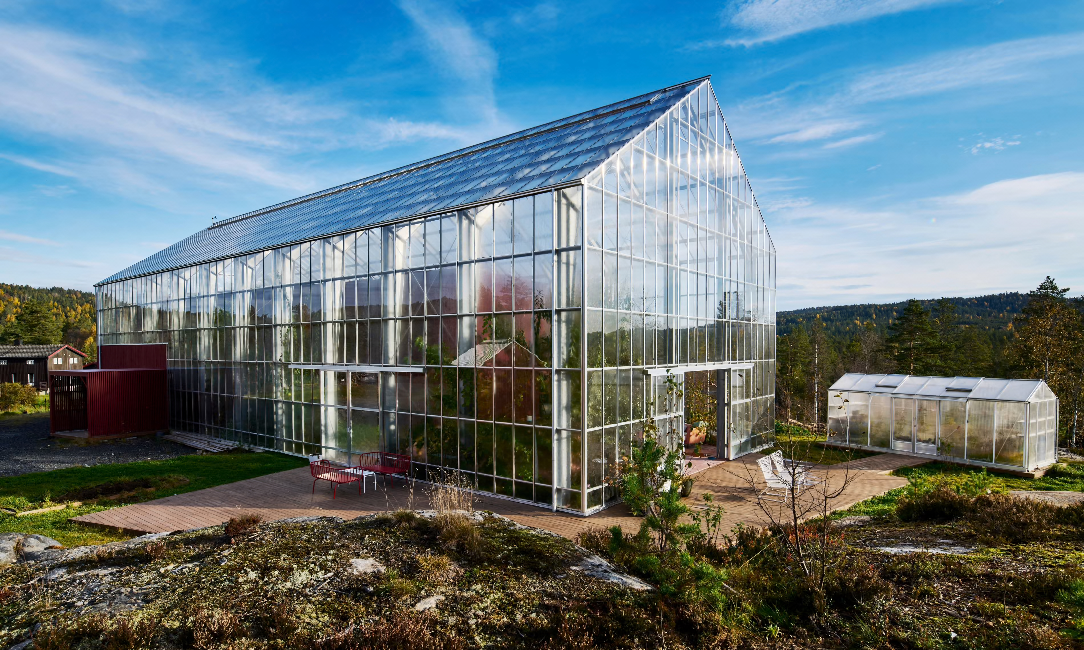 Modern glass greenhouse in rural landscape