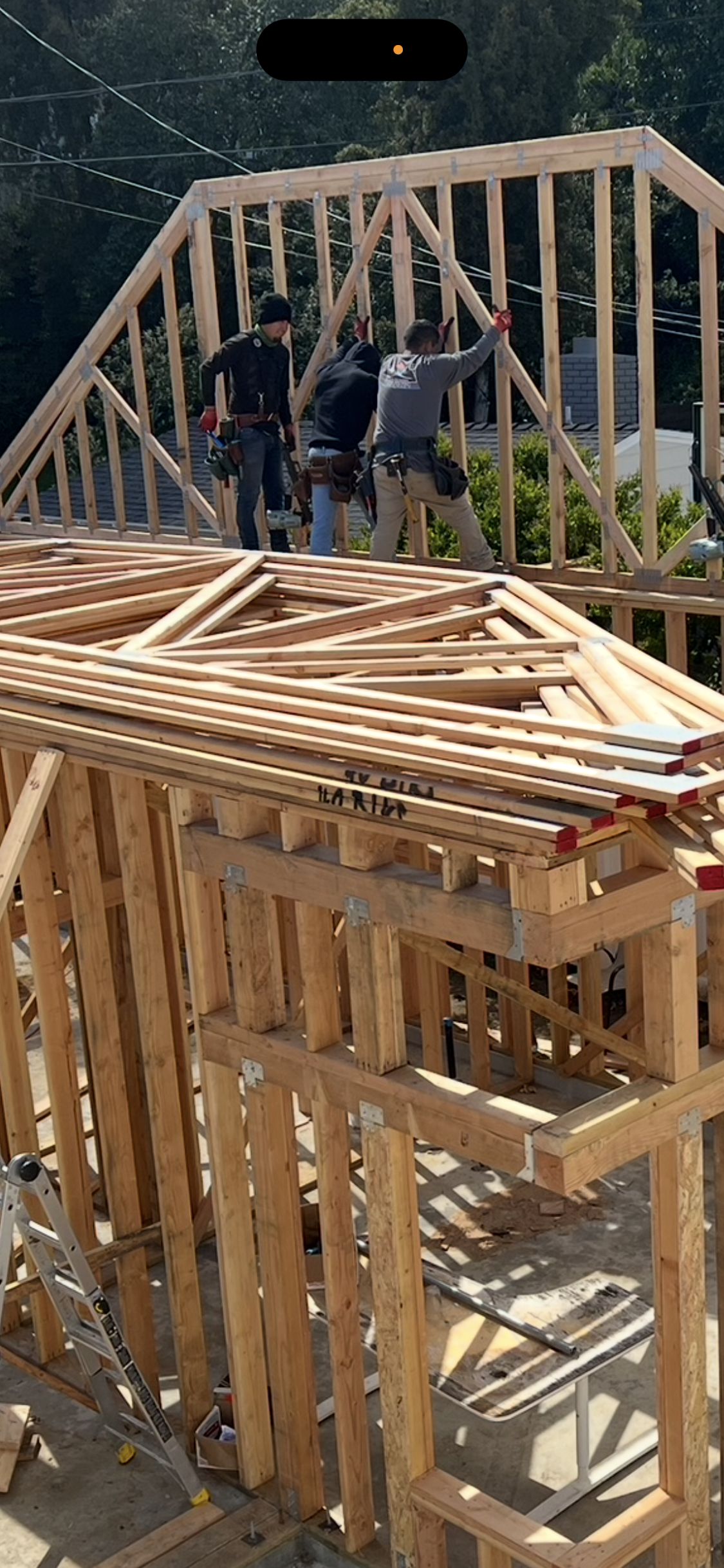Workers installing roof trusses on the ADU frame