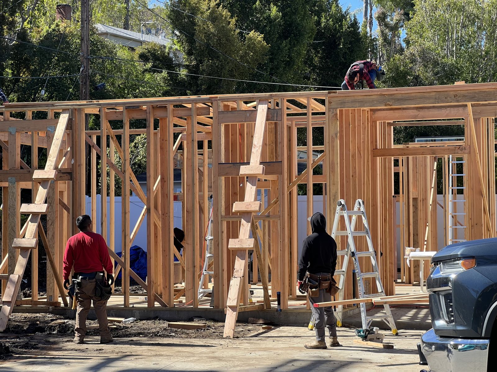 ADU framing crew on site with tools and lumber