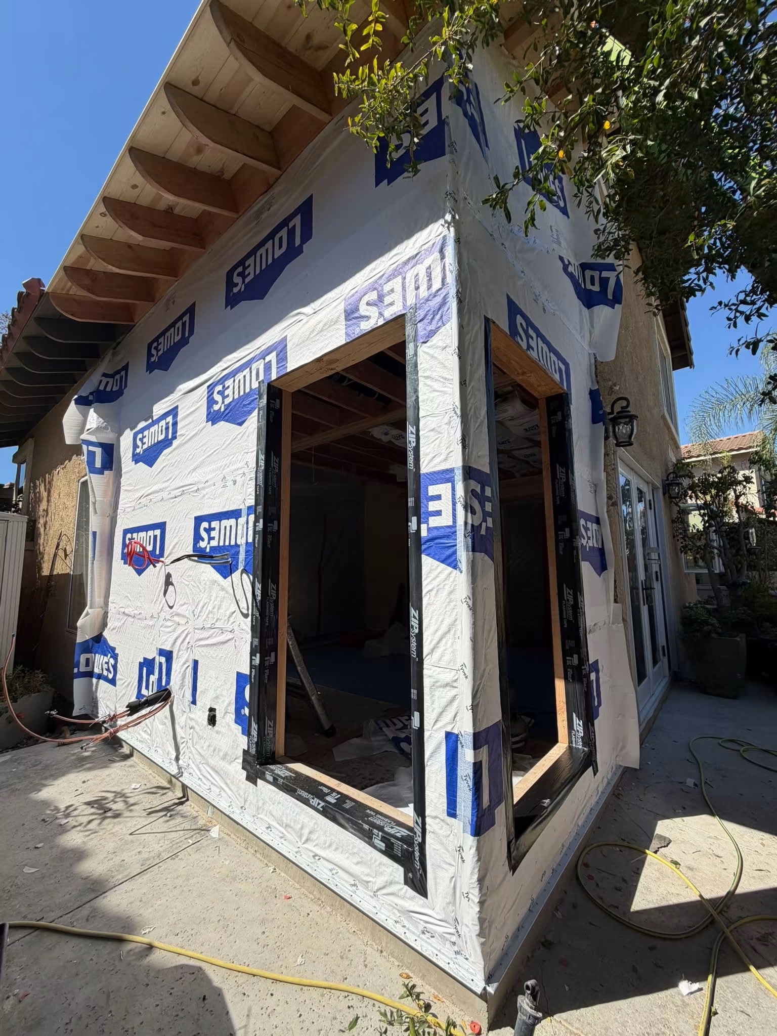 ADU exterior frame wrapped in house wrap with framed window opening