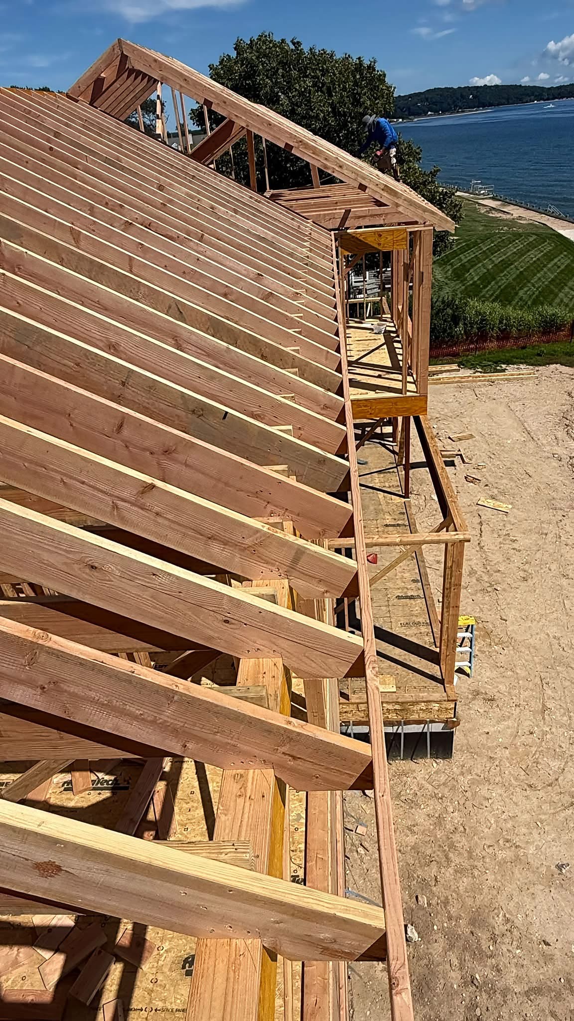 ADU addition roof framing overlooking a waterfront