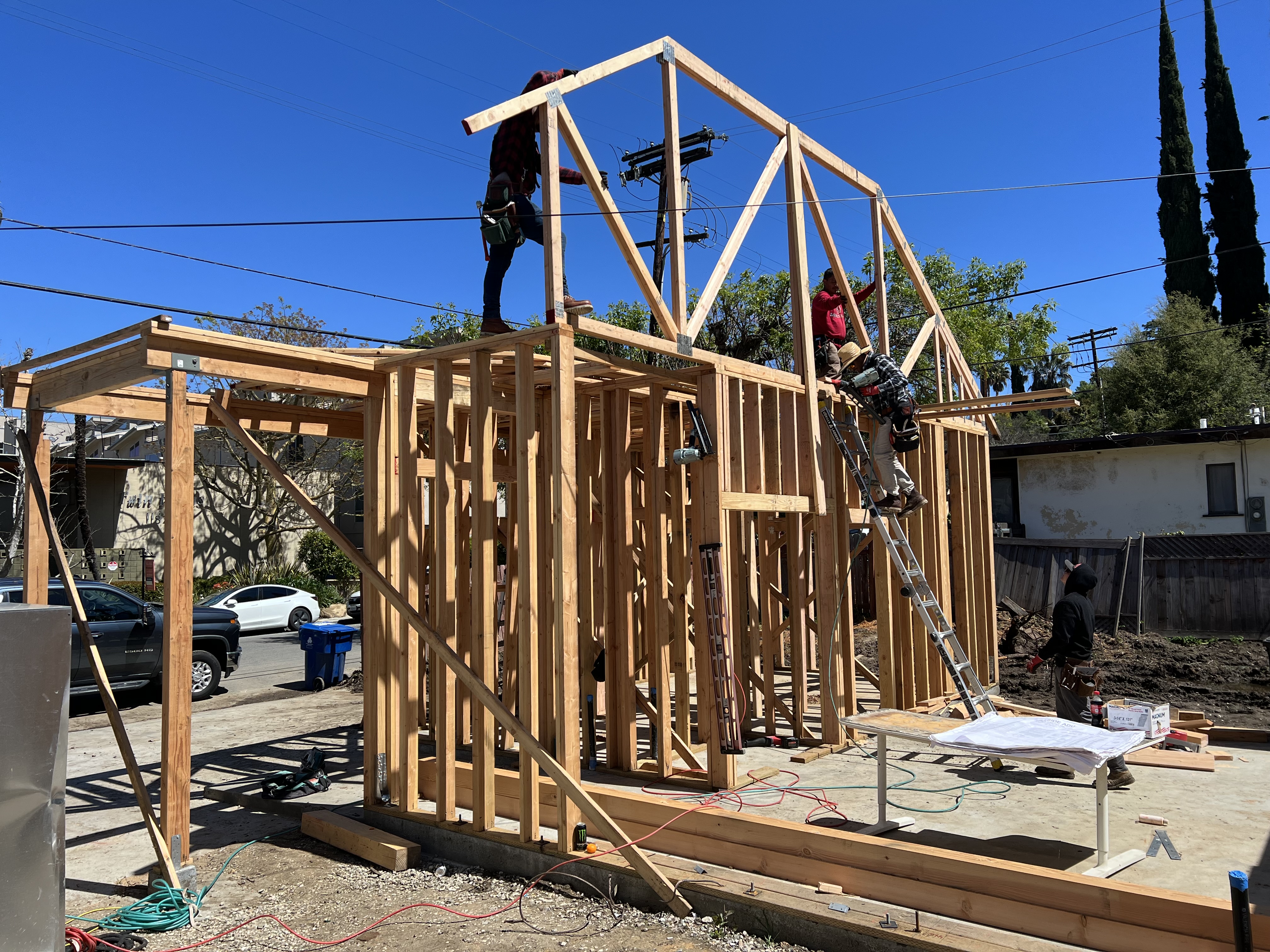 ADU wall framing and roof trusses with crew working on site