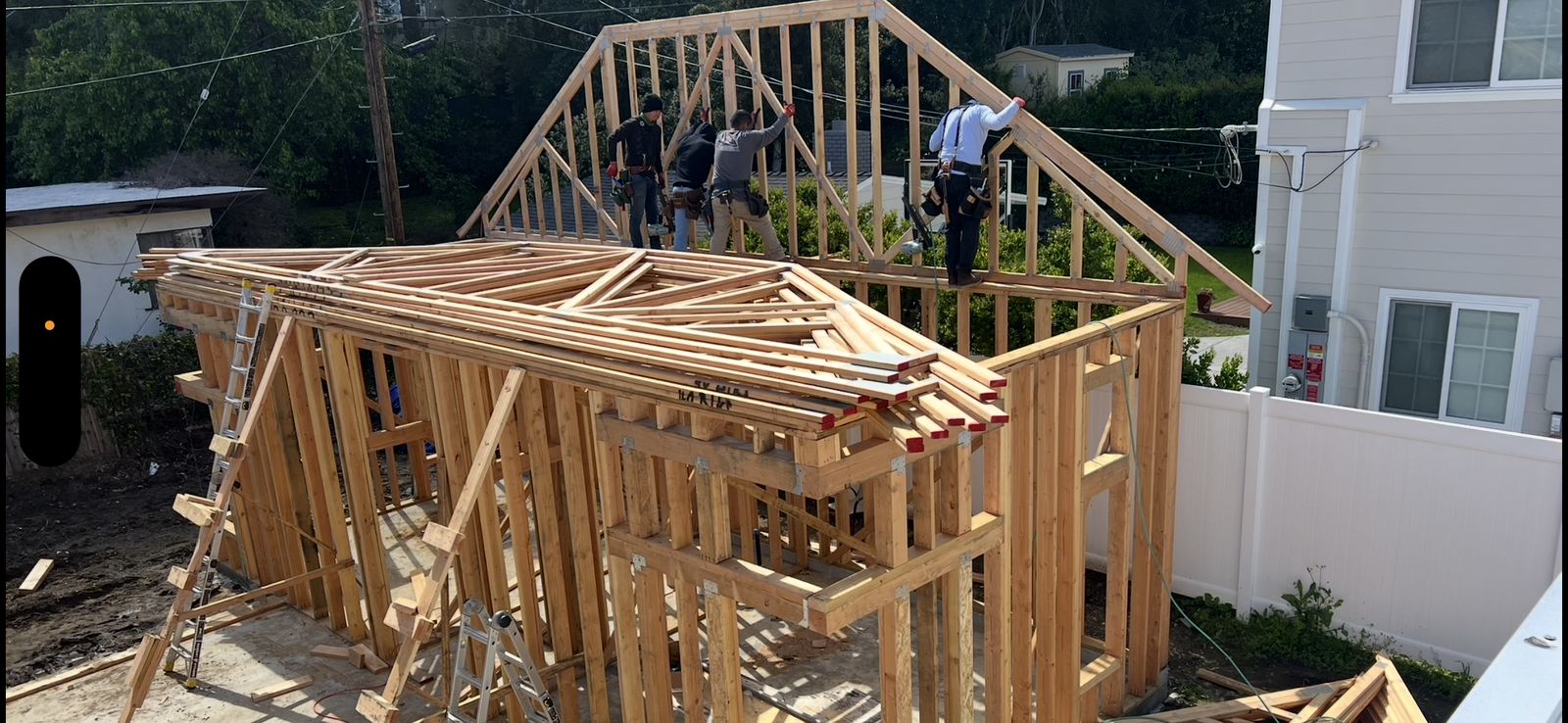 Crew installing a triangular roof gable truss on the ADU