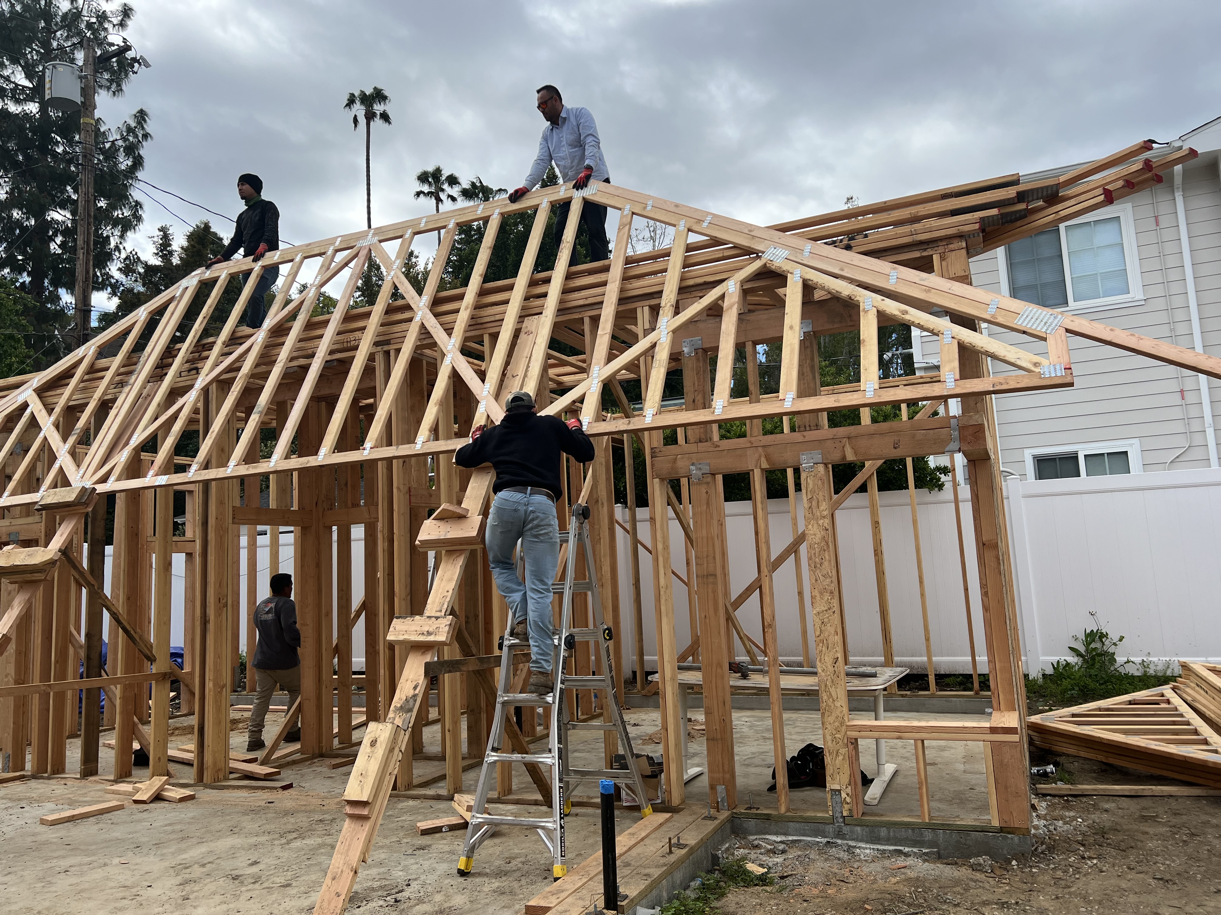 Crew installing roof trusses on the ADU frame