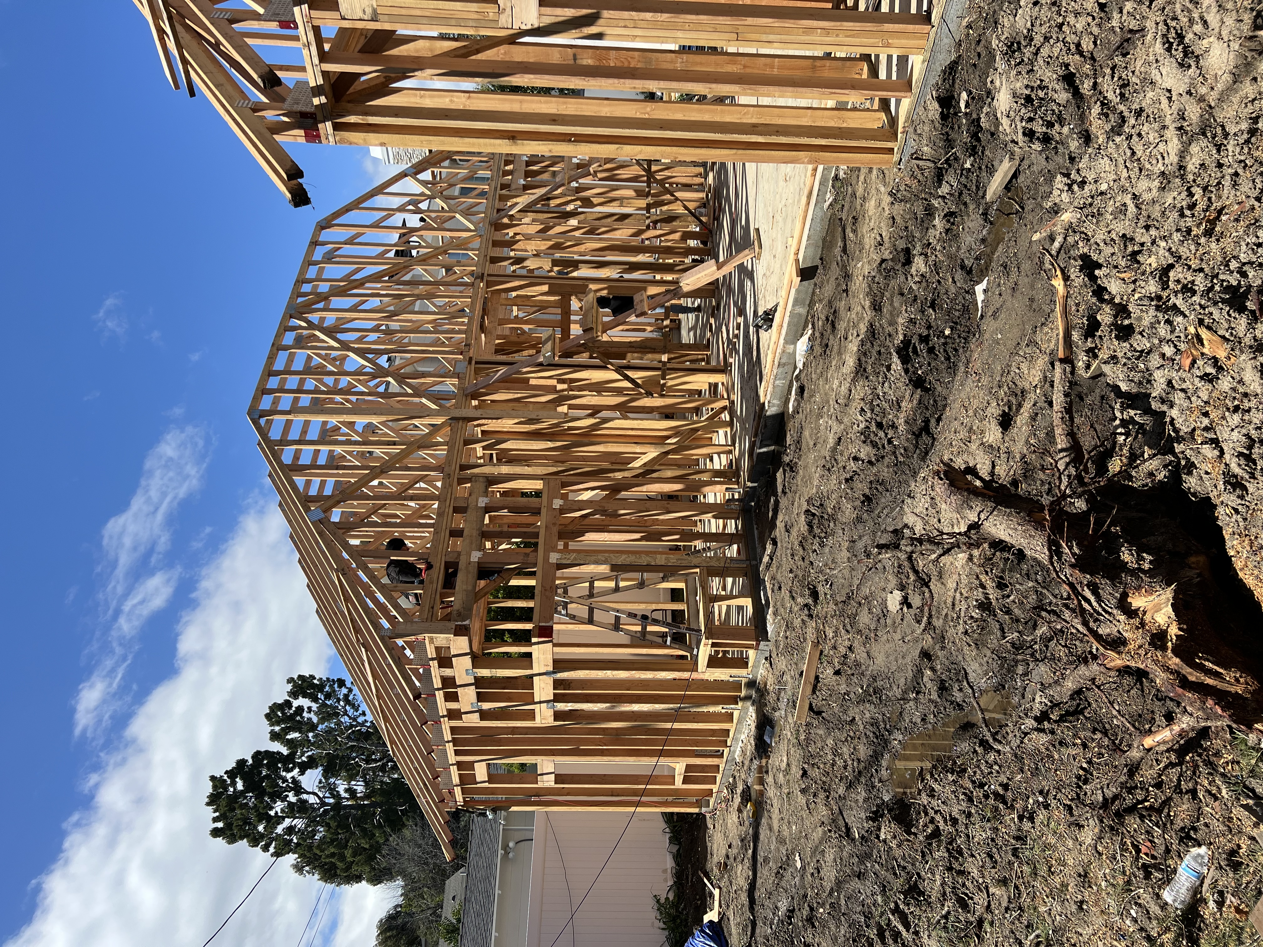 Elevated view of ADU wood framing with workers on the structure