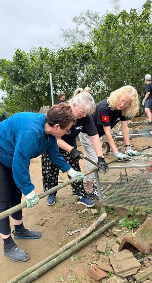 Three Way To Travel volunteers working together on a project frame