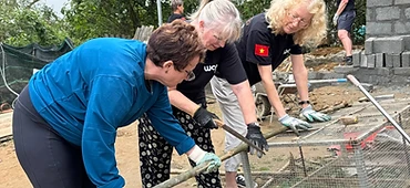 Three volunteers working on the wire-mesh frame