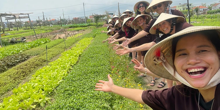 Way To Travel group in conical hats in a Vietnamese vegetable garden