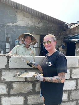 Two Way To Travel volunteers working together with a trowel