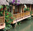 Thatched bungalows on stilts over the water at Tam Coc Nature