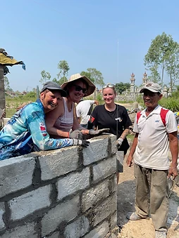 Two Way To Travel volunteers building a wall together
