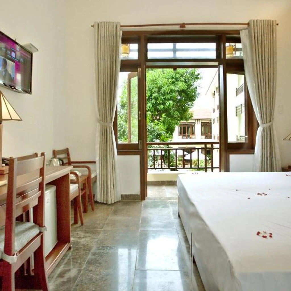 Comfortable queen bedroom with balcony at Hoi An TNT Villa