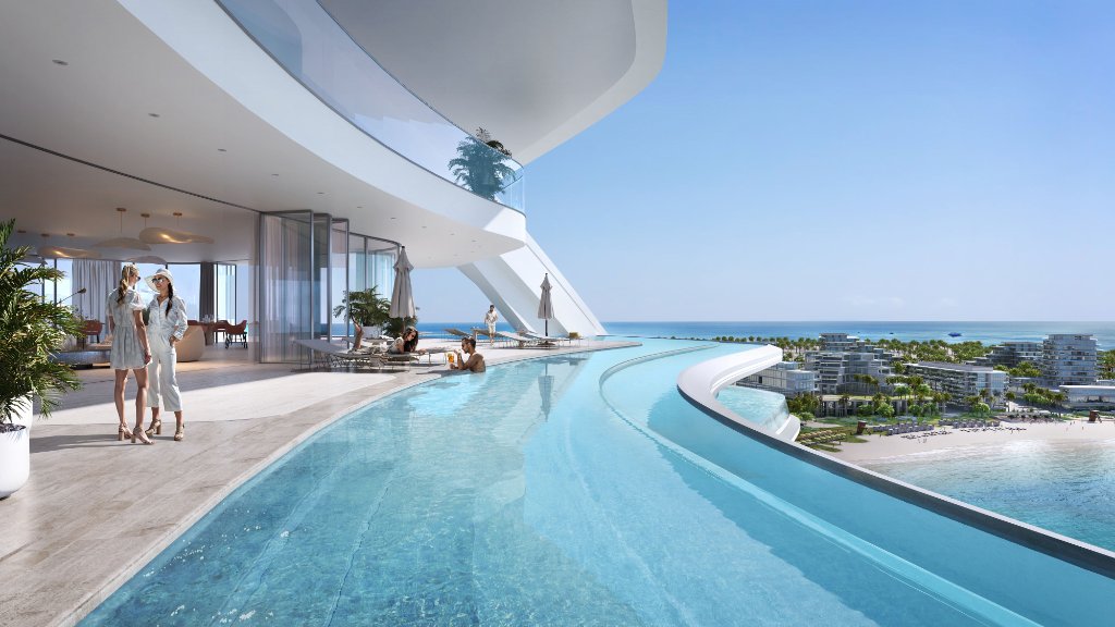 Oystra Rooftop Pool and Coastal View Oystra rooftop pool with curved infinity edge overlooking beach resort and coastline