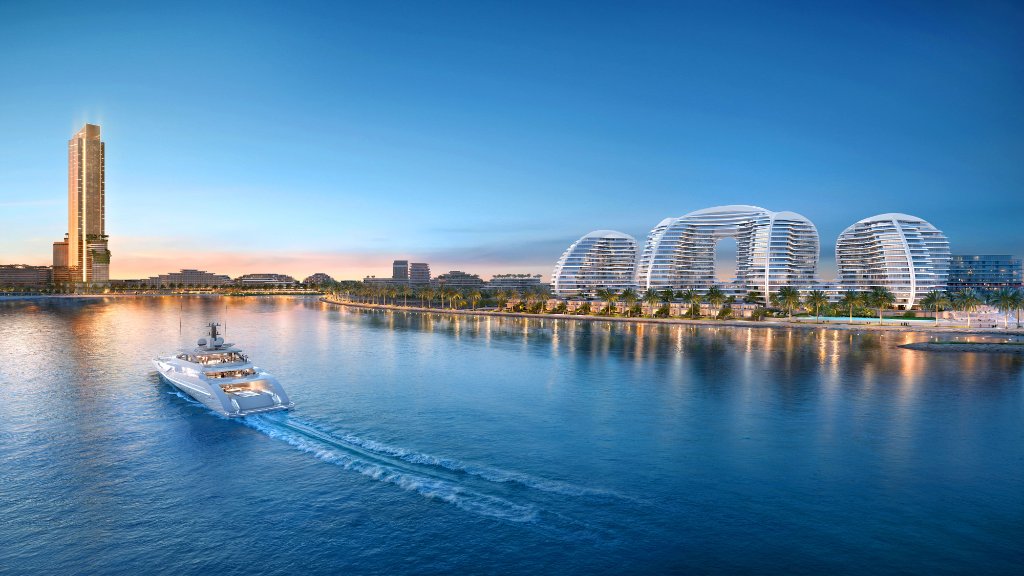 Oystra Development Proximity to Wynn Casino Oystra development at twilight with yacht and Wynn casino tower in distance on Al Marjan Island