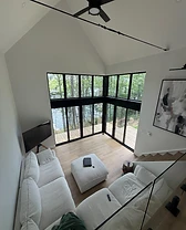 High-angle view of a bright split-level living area with a sectional sofa