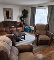 Living room with leather sofas and recliners