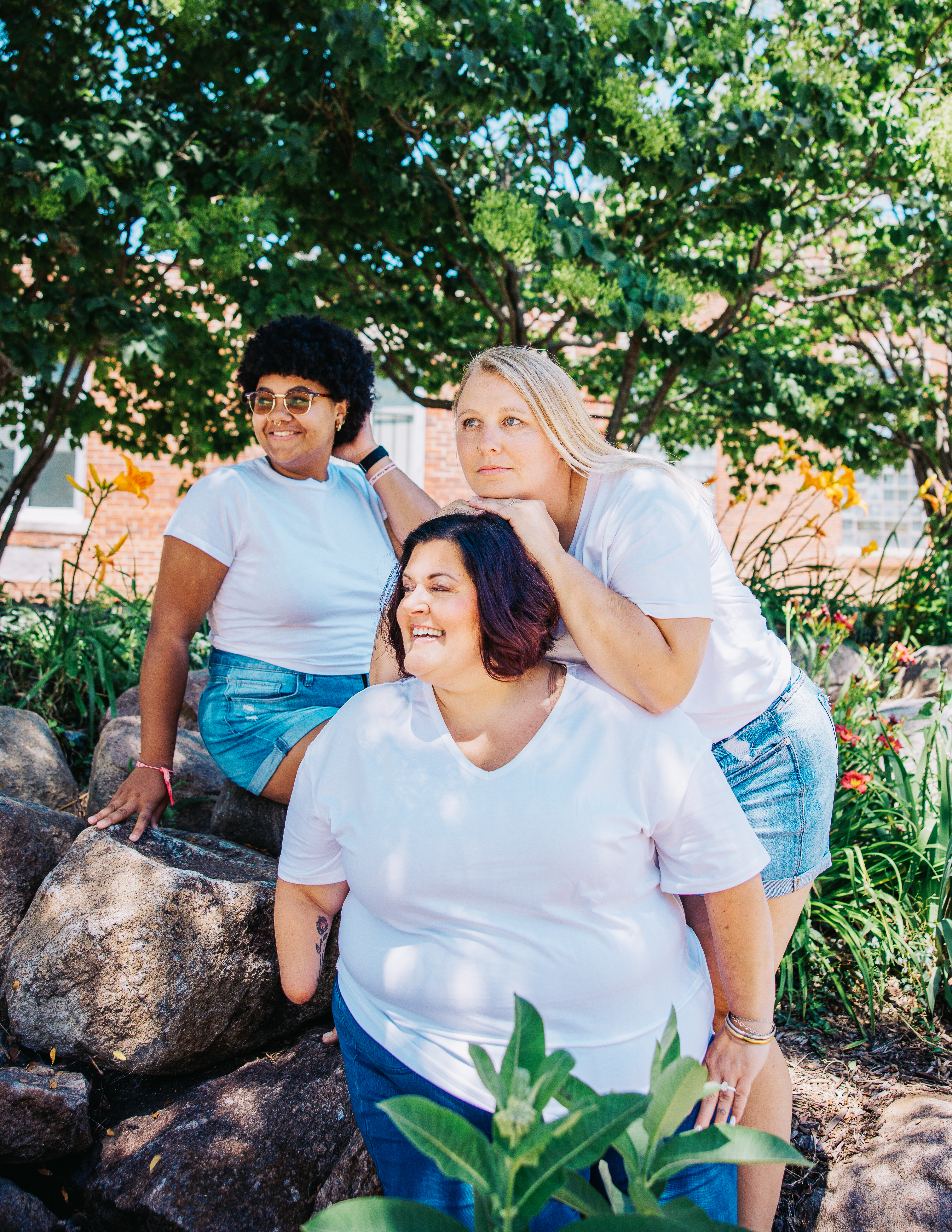 The three women of Two Chicks Fluff and Fold — Cortney, Keeley, and Tonya — together outdoors