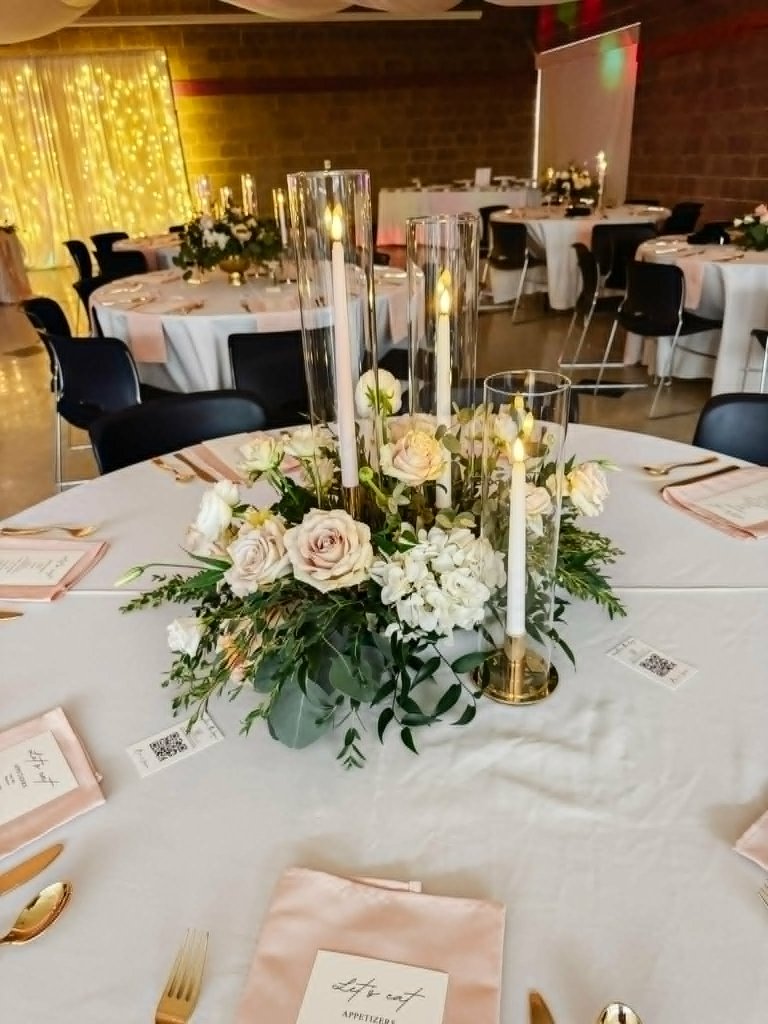 Elegant wedding table with white linens and floral centerpiece