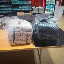Clear bags of neatly folded white towels and linens prepared for a commercial client