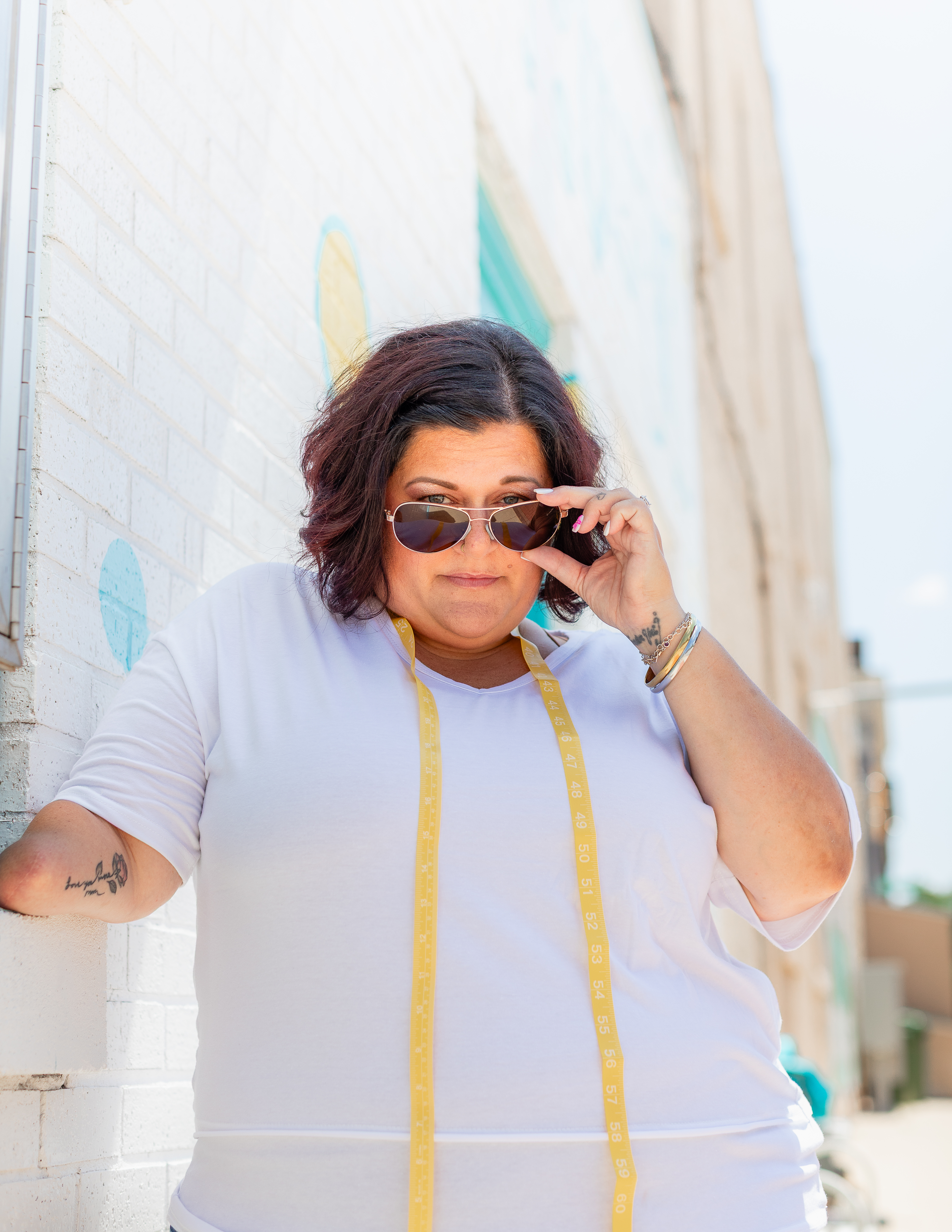 Tonya, Two Chicks formalwear specialist, wearing a measuring tape