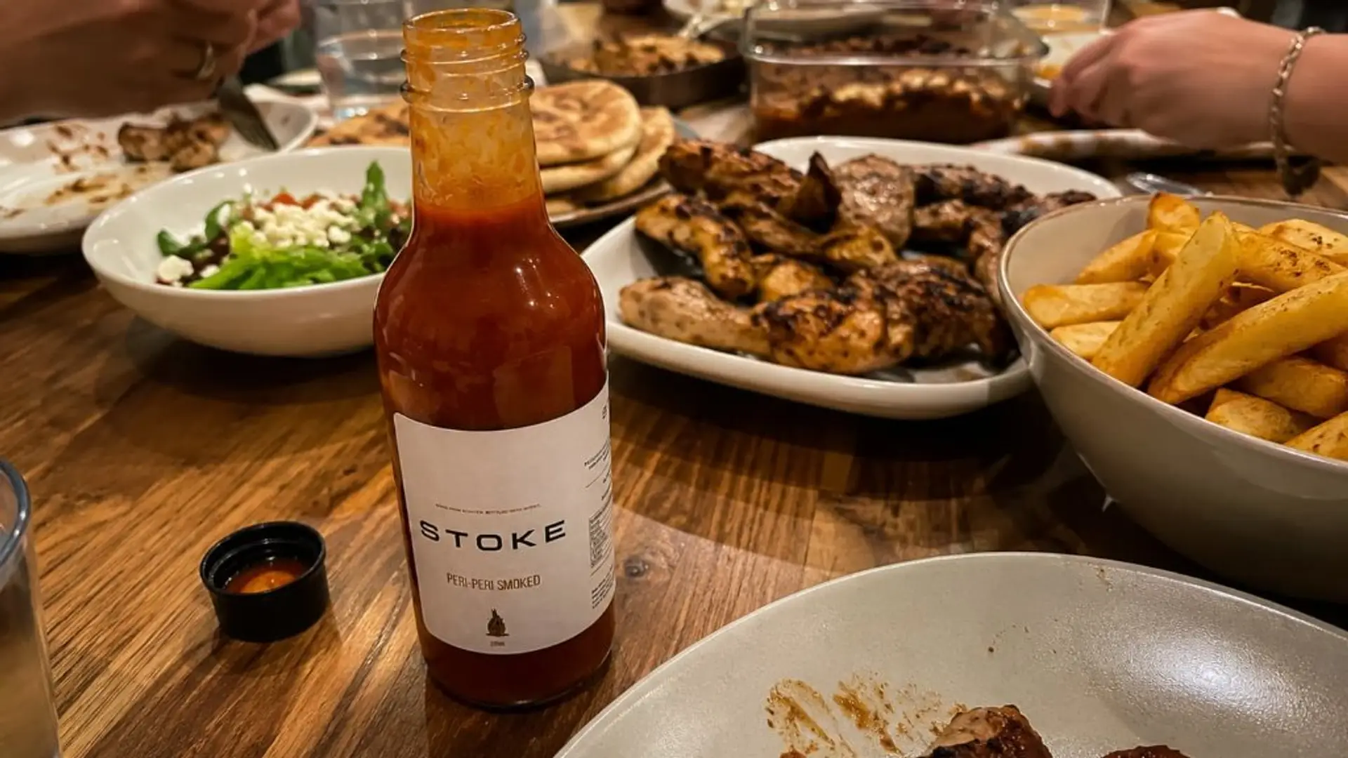 STOKE peri-peri sauce on a family table with food