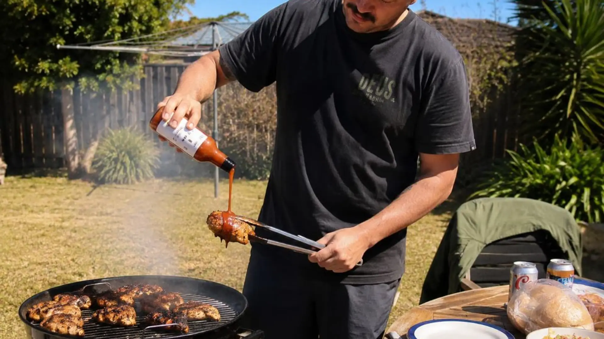 Pouring STOKE peri-peri sauce on chicken at a BBQ