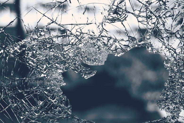 Close-up of broken safety glass with spiderweb cracks
