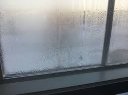 Misted double-glazed sealed unit with condensation between the panes