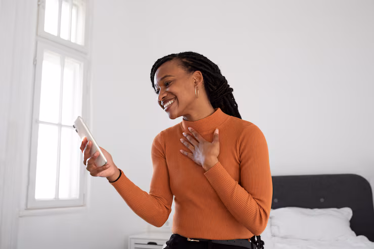 Woman smiling while reading a message on her phone