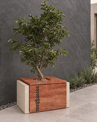 Sculptural stacked stone planter with a leafy tree against a bronze and beige wall