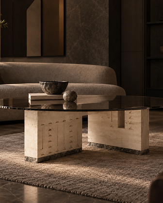Sculptural side table with circular green marble top and tiered dark stone base in a moody luxury interior