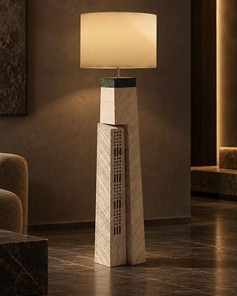 Vertical wall-mounted stone light fixture with carved geometric relief patterns emitting warm glow on wood paneling