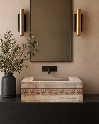 Rectangular natural stone wash basin with decorative geometric inlay on a dark vanity beneath a mirror and brass wall lights